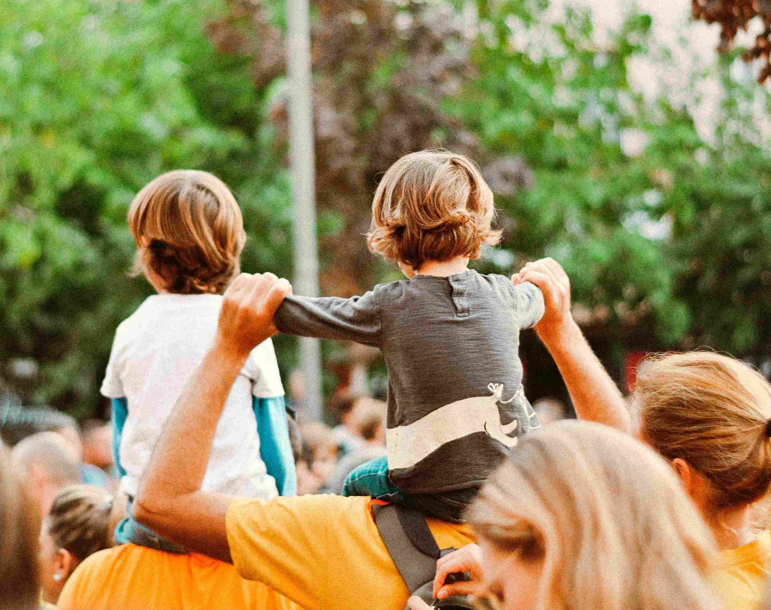 Kid on parents shoulders